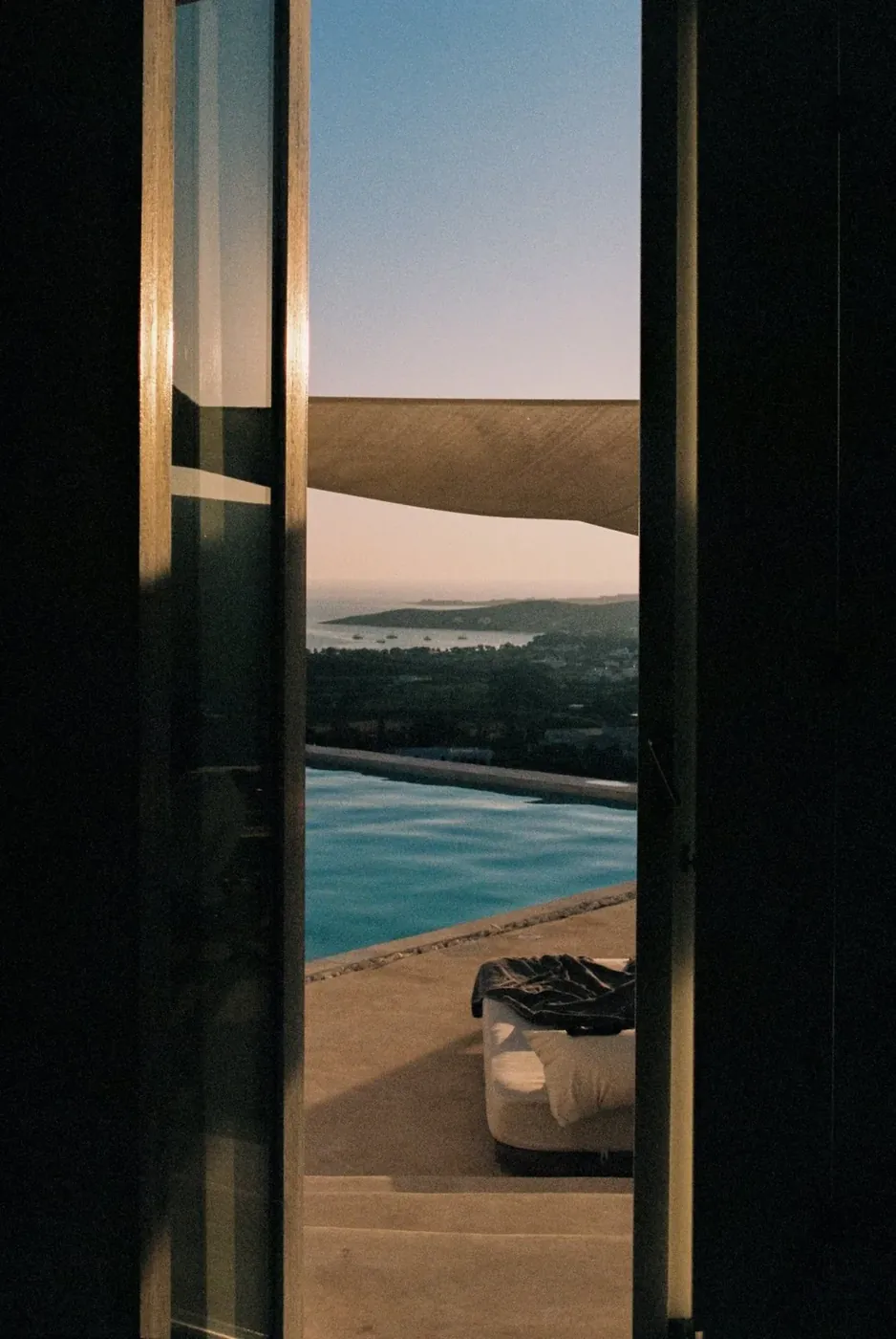 Villa website hero — pool and sea at dusk